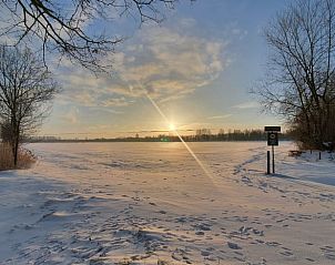 Winter sunrise at Holiday home in Aalten, located in the picturesque Achterhoek, Gelderland, surrounded by snowy fields.