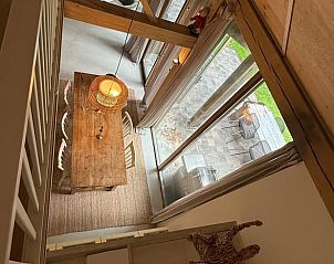 Dining Room in Holiday Home in Lochem, Achterhoek, Gelderland, with wooden table and garden view.