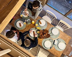 Cozy meal at Holiday Home in Lochem, Achterhoek, Gelderland, with family at table.