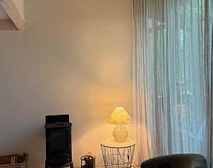 Cozy sitting area in Holiday Home in Lochem, Achterhoek, Gelderland, with atmospheric lighting.