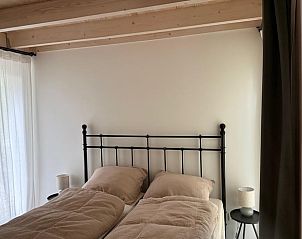 Bedroom with double bed in Holiday Home in Lochem, Achterhoek, Gelderland, with natural light.