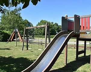 Slide and swings at Holiday home in Vorden, child-friendly accommodation in Achterhoek, Gelderland.