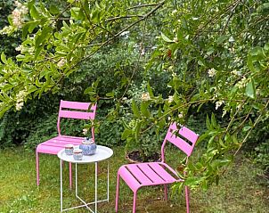 Knusse zitplek in de tuin van Vakantiehuisje in Neede, Achterhoek