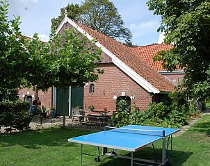 Huisje in Winterswijk Woold, vakantiehuis in de Achterhoek, Gelderland met een groene tuin en tafeltennistafel voor ontspanning.