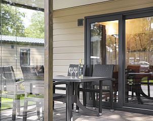 Buitenveranda van De Vlinderhoeve 2C, Kring van Dorth, met glazen schuifdeuren.