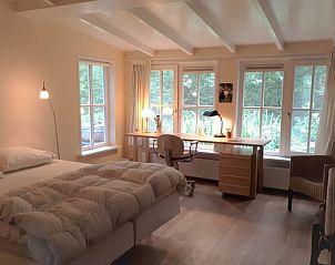 Attractive bedroom in Holiday home in Joppe, Achterhoek, with large desk and view of green nature in Gelderland.