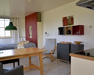 Cozy indoor area of Holiday Home in Empe, Gelderse Valley, with a comfortable sitting area and dining area for a relaxing stay.
