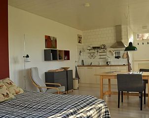Cozy indoor area of Holiday Home in Empe, located in Gelderse Valley, Gelderland, with kitchen and dining area.