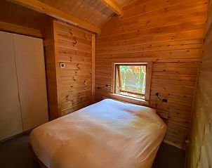 Cozy bedroom in Holiday home in Beekbergen, Veluwe, with wooden walls and soothing atmosphere in Gelderland.