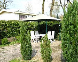 Overdekte zithoek in de tuin van Stacaravan op de Veluwe, Harskamp, ideaal voor buiten dineren.