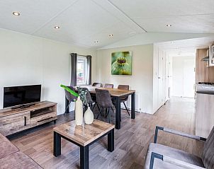 Stylish dining room and sitting area in Holiday home sleeps 6 in Ede, Veluwe, ideal for family gatherings.