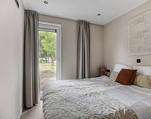 Slaapkamer in Heidenhof vakantiehuis, Ede, Veluwe met uitzicht op de tuin.