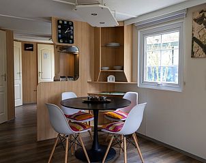 Cozy dining area in Holiday Home in Emst, Gelderland, with colorful pillows.