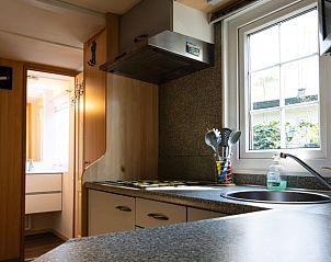 Kitchen with view in Holiday home in Emst, Veluwe, with access to the bathroom.