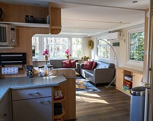 Overview of the kitchen and living room in Holiday Home in Emst, Veluwe.