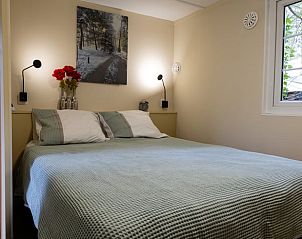 Cozy bedroom in Holiday Home in Emst, Gelderland, with large window.