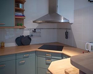 Modern kitchen in Holiday home in Emst, located in Veluwe, Gelderland, with wooden worktop and stylish extractor.