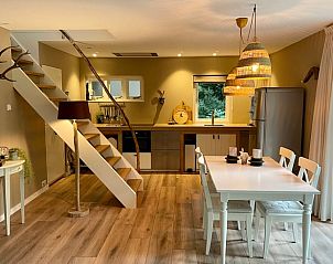 Kitchen and dining area of Cottage in Emst, vacation home in Veluwe, Gelderland.