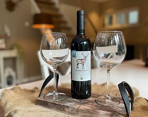 Bottle of wine in dining area of cottage in Emst, Veluwe, Gelderland.