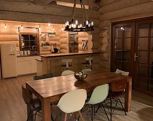 Cozy interior of Holiday Home in Emst, Veluwe, Gelderland with wooden interior and atmospheric lighting.
