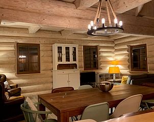 Cozy interior of Holiday Home in Emst, Veluwe, Gelderland with wooden interior and atmospheric lighting.