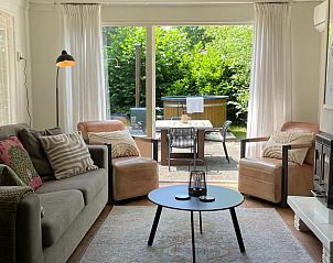 Cozy living room of cottage in Ermelo, Veluwe, overlooking the green terrace.