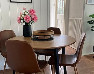 Dining table with flowers in Holiday home in Ermelo, Veluwe, perfect for cozy meals.