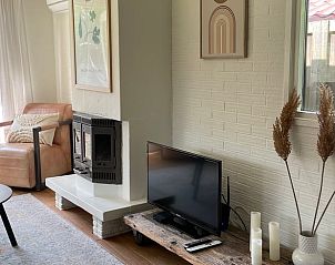 Cozy sitting area with fireplace in Holiday home in Ermelo, Veluwe, for relaxation.