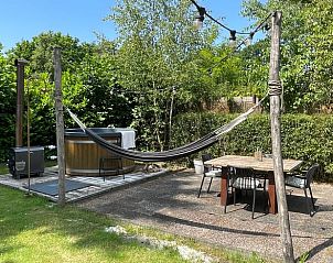 Cozy terrace with hammock and hot tub at Holiday home in Ermelo, Veluwe, surrounded by nature.
