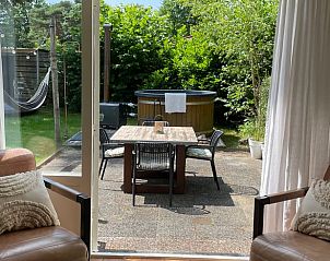 View from the living room on the terrace of Holiday home in Ermelo, Veluwe, with hot tub.