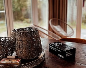 Cozy indoor area of Cottage in Ermelo, Veluwe, where games and decorative lanterns create a warm atmosphere.
