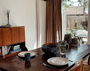 Cozy dining room in Cottage in Ermelo, Veluwe, Gelderland with garden view, perfect for a relaxing vacation home experience.