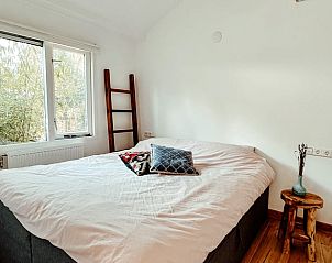 Attractive bedroom in cottage in Ermelo, Veluwe, with comfortable bed and view of the nature of Gelderland.
