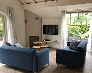 Cozy living room in Holiday home in Ermelo, Veluwe overlooking the garden.