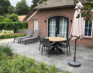 Spacious terrace with lounge chairs at Holiday home in Ermelo, Veluwe, Gelderland.