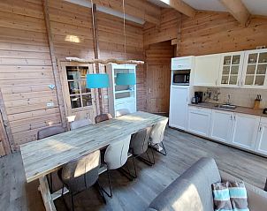 Cozy indoor area of Huisje in Ermelo, vacation home in Veluwe, Gelderland, with wooden interior and spacious dining area.