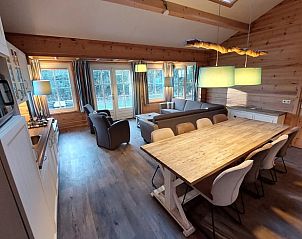 Cozy living room in Cottage in Ermelo, Veluwe, with wooden interior and spacious dining area, ideal vacation home in Gelderland.