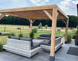 Outdoor seating at Holiday Home in Garderen, Veluwe, surrounded by nature and tranquility.