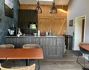 Kitchen and dining area in Holiday Home in Garderen, Veluwe, with warm wood accents.
