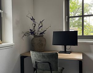 Workroom in Holiday home Sprielderbosch 26 De Beuk in Putten, Veluwe, with desk and decorative elements.