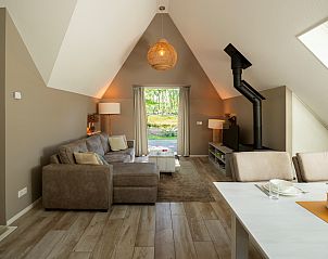 Cozy living room with wood stove in Holiday home Sprielderbosch 25 'Meneer de Uil' in Putten, Veluwe.