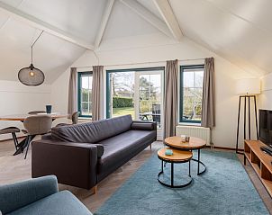 Gezellige woonkamer van Veluwse Hoevewoning 4 in Putten, Veluwe. Comfortabel vakantiehuis met uitzicht op de groene omgeving van Gelderland.