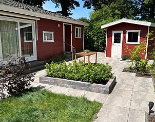 Enjoy the sunny terrace at Huisje in Putten, a charming cottage in Veluwe, Gelderland, surrounded by green nature.