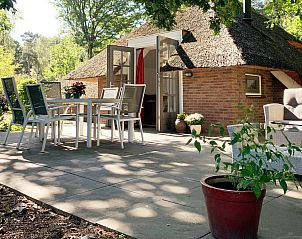 Relax on the spacious terrace of Holiday home Sprielderbosch 38 The Wooden Owl, surrounded by nature in Putten, Veluwe.