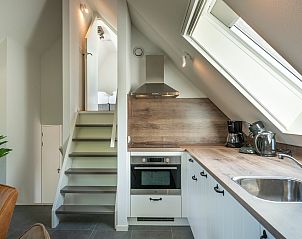 Eethoek in Vakantiewoning Sprielderbosch 44 Green Balance, vakantiehuis in Putten, Veluwe met uitzicht op de natuur.