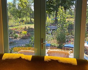 View from the living room of Cottage in Voorthuizen, Veluwe, Gelderland, of the colorful garden.