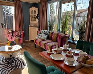 Cozy living room in Holiday Home in Voorthuizen, Veluwe, with colorful sofa and dining area.