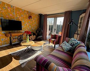 Stylish sitting room in Holiday Home in Voorthuizen, Veluwe, with modern furniture and art.