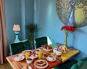 Breakfast set in Holiday Home in Voorthuizen, Veluwe, with colorful dishes and decorative art.