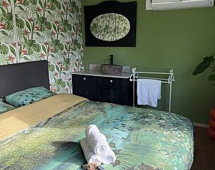 Comfortable bedroom in Holiday Home in Voorthuizen, Veluwe, with green theme and modern furniture.